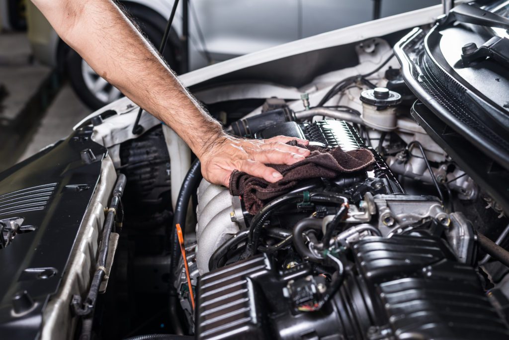 Sponge Car - A man Cleaning the Engine of the Car