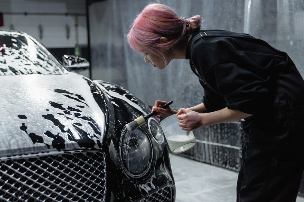 Wash Girl Cleaning the Head Lights